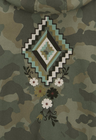 close-up-of-a-camouflage-hoodie-featuring-a-large-geometric-diamond-patch-in-black-white-and-teal-with-embroidered-white-and-black-flowers-below
