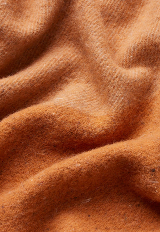 a-close-up-of-draped-camel-colored-wool-fabric-with-a-soft-brushed-texture